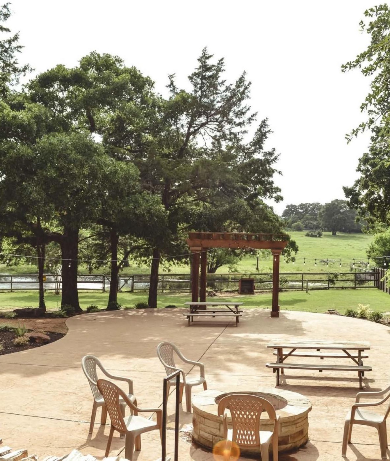 The patio and fire pit beside the pond